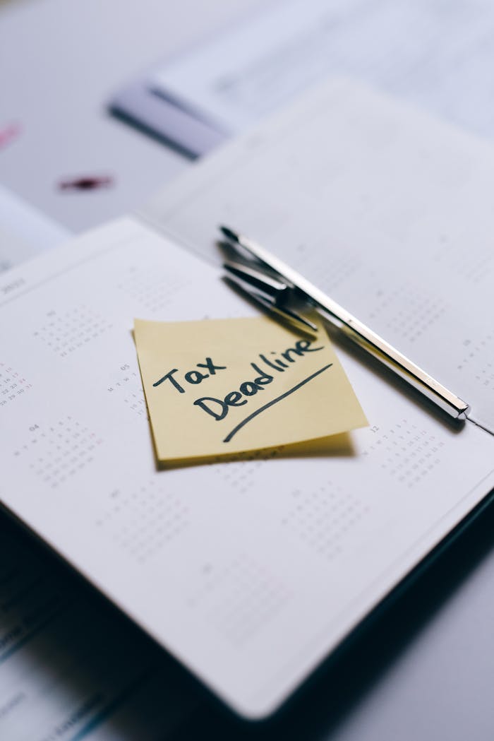 services-01 Sticky note on calendar highlighting tax deadline with pen nearby.